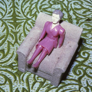 Purple Woman/ Gray Chair/ Green Rug